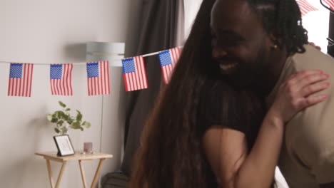 woman at home welcoming friends arriving for party celebrating american independence day 4th july