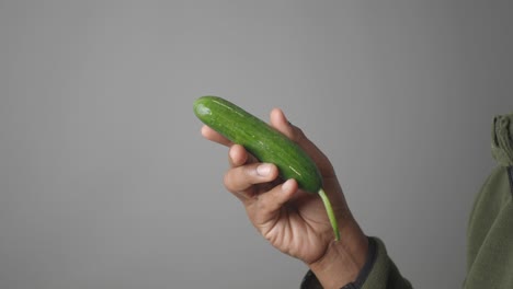 person holding a cucumber