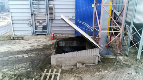 underground premise with open lid over it. basement for storing charcoal at the present day granary complex.