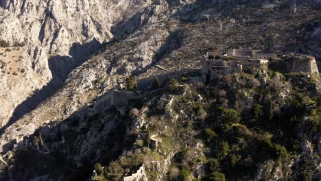 aerial - ancient city walls, kotor, montenegro, unesco world heritage site, backwards