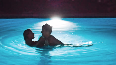 swimming pool at a luxury, tropical resort at night