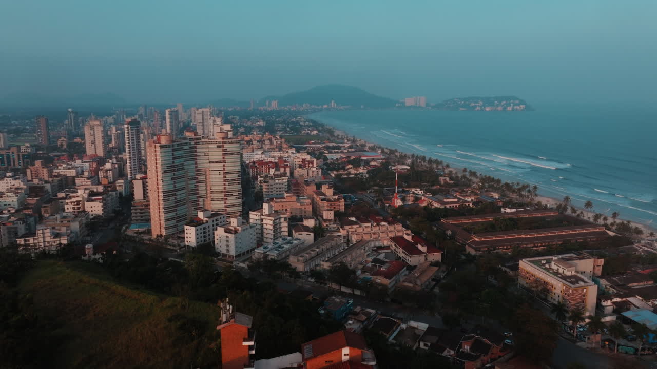 Aerial View of a Coastal City Beach at Sunset