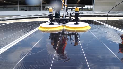 Worker-Use-Machine-to-wash-Solar-Cell-Panel,-Daylight