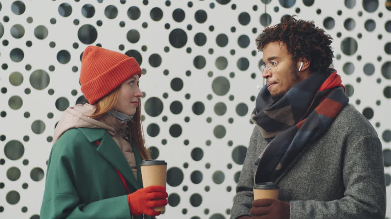 Couple enjoying coffee outdoors in winter