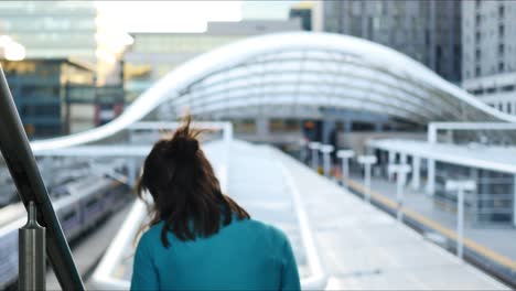 bashful woman in denver union station turns and walks down the stairs