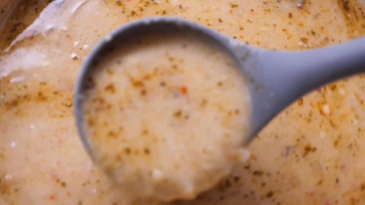 Close-up of Creamy Soup Being Stirred in a Pot