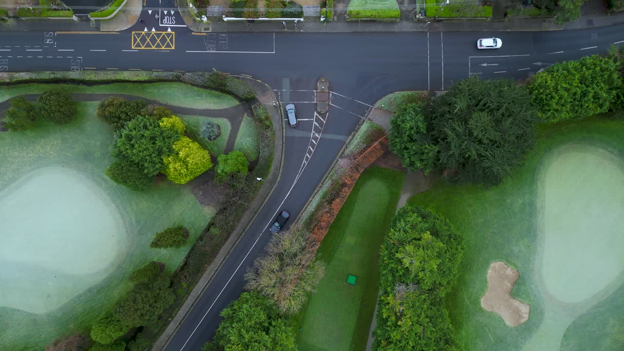 bird eye view looking down to a junction in South Dublin - a road with intense traffic during afternoon time - frozen grass in the Milltown Golf club - South Dublin - Ireland