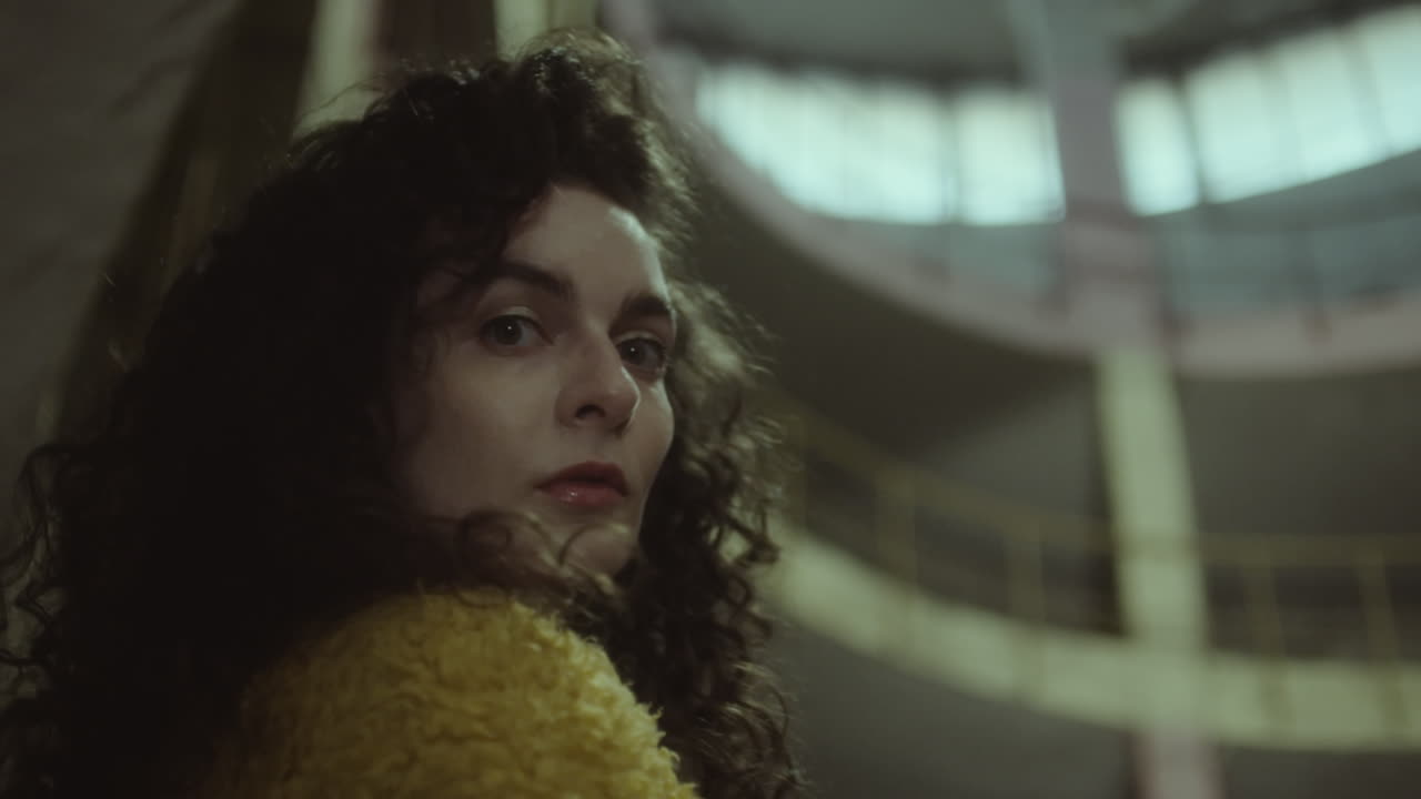 Beautiful Woman Posing for Camera in Dark Building