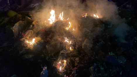 Rubbish-Burning-In-Street-With-Smoke-Rising-At-Night