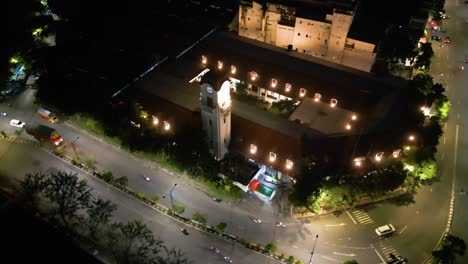 Drone-shot-view-of-"Klokkentoren-van-Lindeteves-Stokvis"-now-occupied-by-Bank-Mandiri-at-night-in-Surabaya,-East-Java