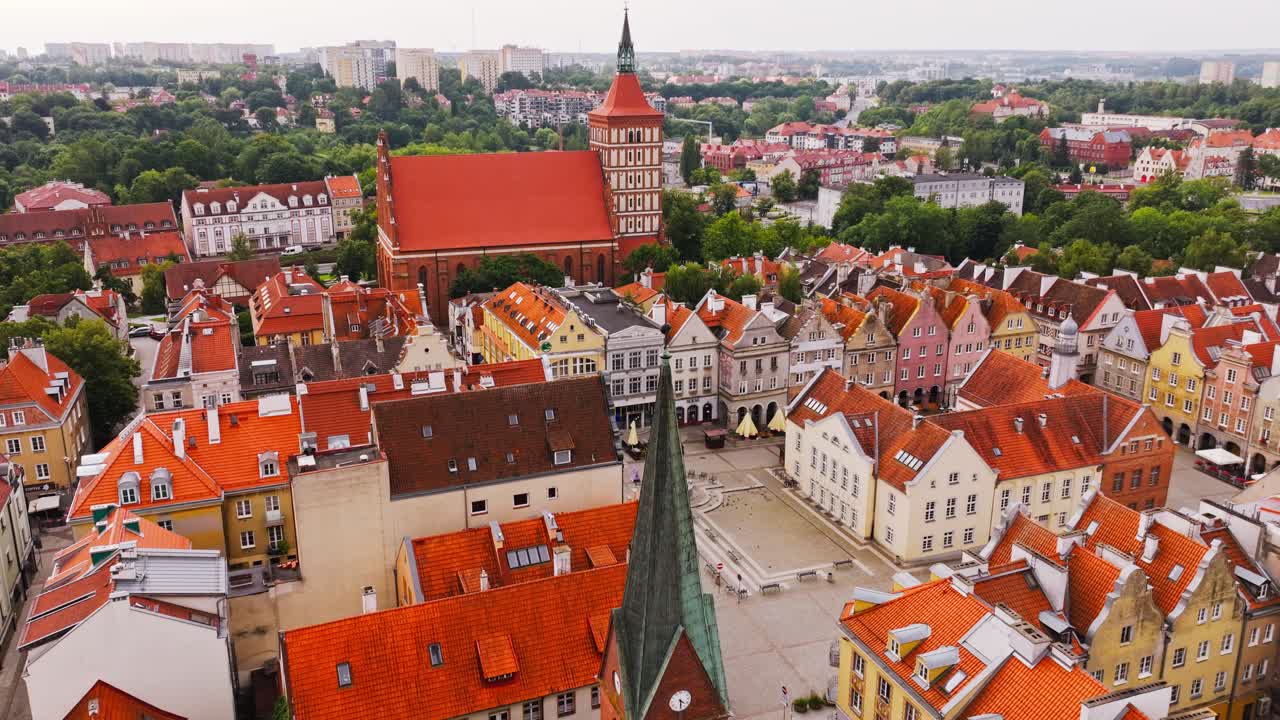 Drone establishing shot showing Olsztyn Old Town square before daily life begins