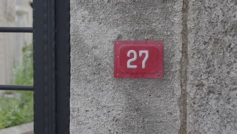 house number 27 on a concrete wall