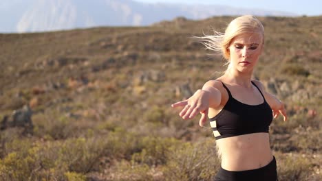 beautiful blond female model doing yoga in nature with stunning scenery