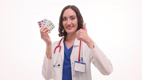 Female Doctor Holding Pills and Giving a Thumbs Up