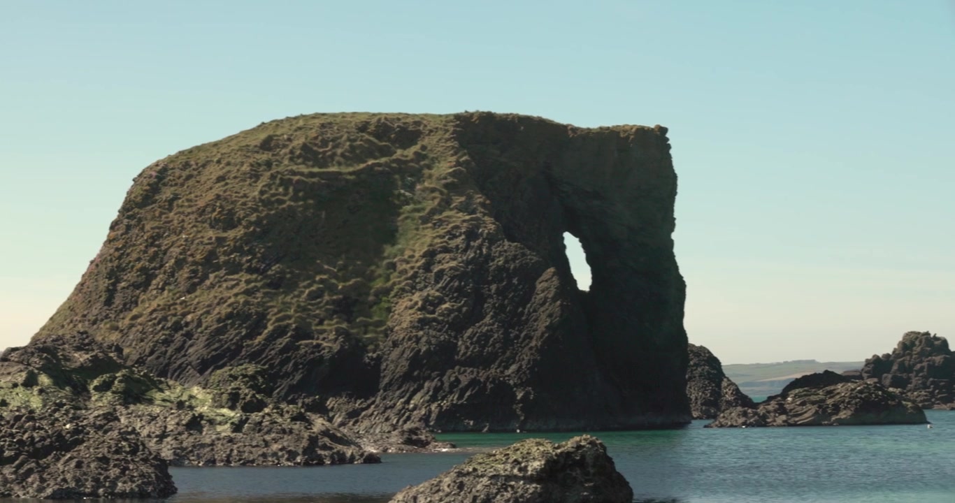 panning shot revealing the famous Elephant Rock on the Northern Ireland coast