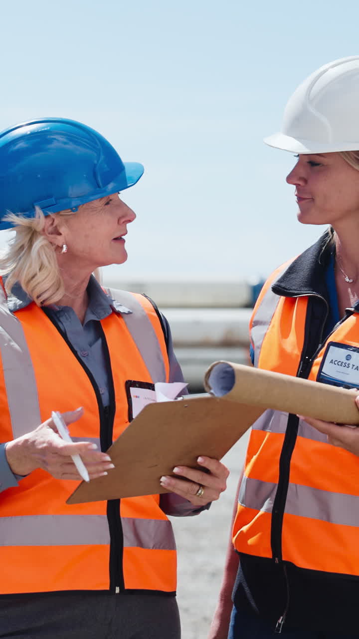 Two Female Engineers Discussing Plans on a Construction Site