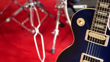 a vintage blue electric guitar on a concert stage in a rock and roll garage band setting