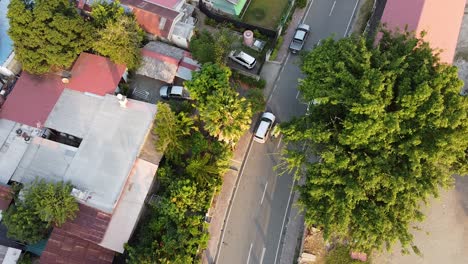 Aerial birds eye view of street vendor pushing cart of fruit and vegetables in capital city of Dili, Timor-Leste, Southeast Asia
