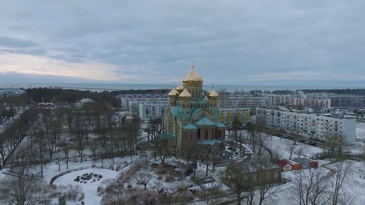 Aerial establishing view of orthodox , distant wide orbiting drone shot