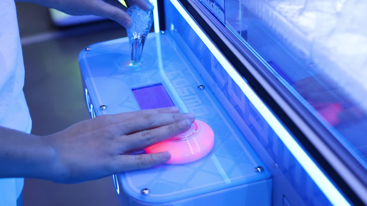 Hands interacting with a glowing game console