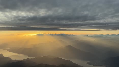 awesome sunset over the italian apls mountains shot from a jet cockpit while flying at 9000m high