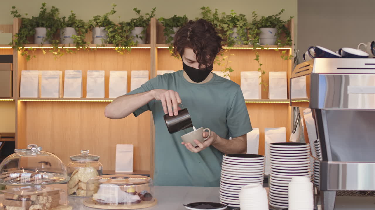 Young Man Making Cappuccino in Coffeeshop