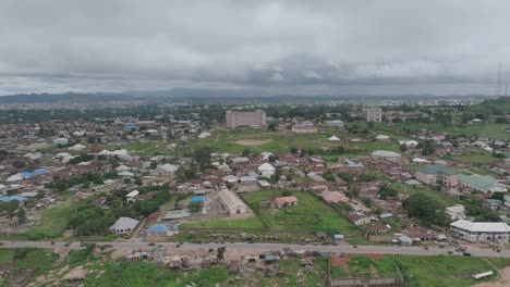 aerial - cityscape in jos plateau, nigeria, truck left
