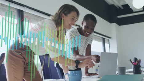 animation of graph over diverse female coworkers standing and discussing reports on laptop