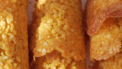 detailed pan right of crispy almond tejas sweets under direct sunlight, revealing texture and color