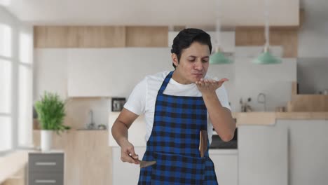 Happy-Indian-cook-tasting-good-food-and-showing-okay-sign