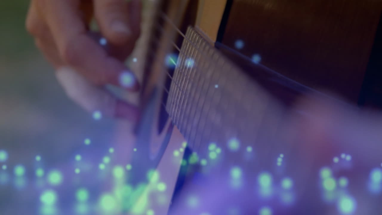 Guitar player pressing steel strings on fretboard in music studio, with floating blue light