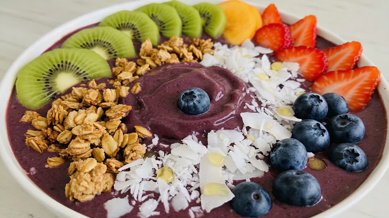 A Colorful and Nutritious Berry Smoothie Bowl Topped with Fresh Fruits, Coconut Flakes, and Crunchy Granola for a Delicious Breakfast Treat