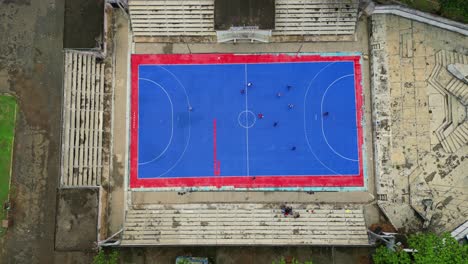 seen from above young people playing football in são tomé,africa.
drone shot descending