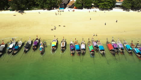 longtail boats waiting for passengers on beaches in thailand