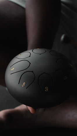person playing a handpan drum