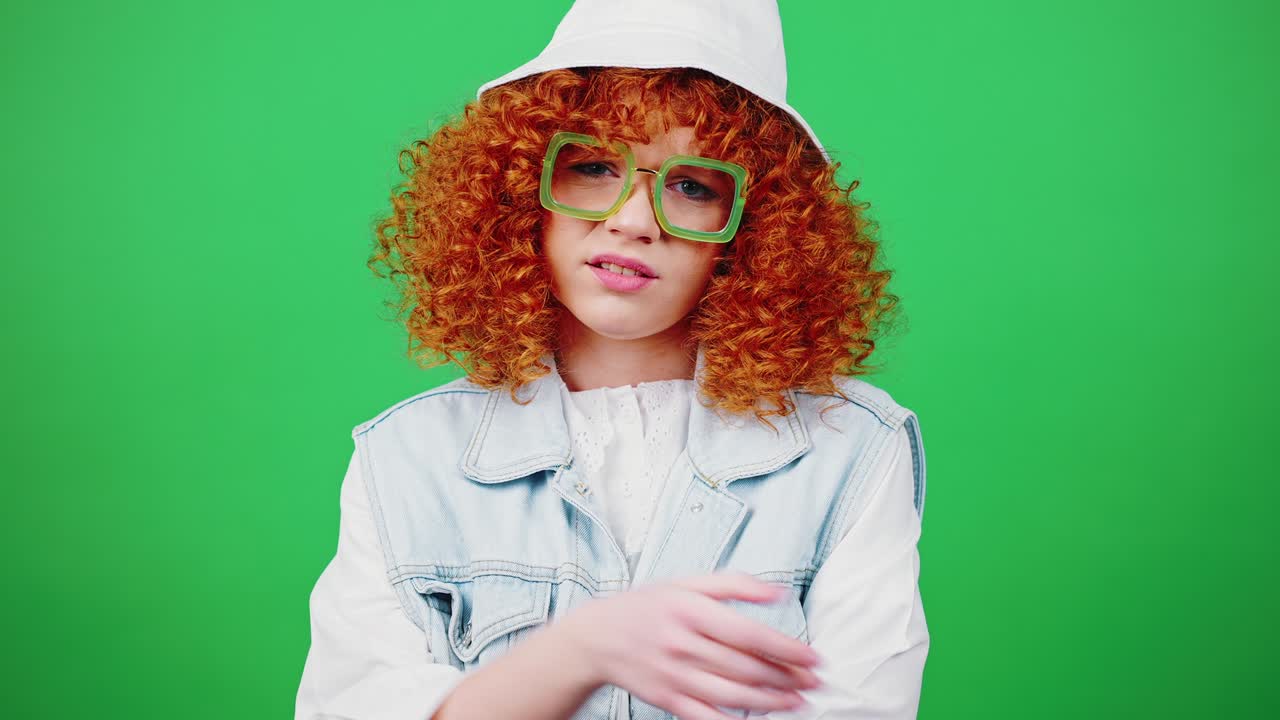 Young boring redhead curly lady wearing eyeglasses and panama hat showing fed up gesture, expressing denial