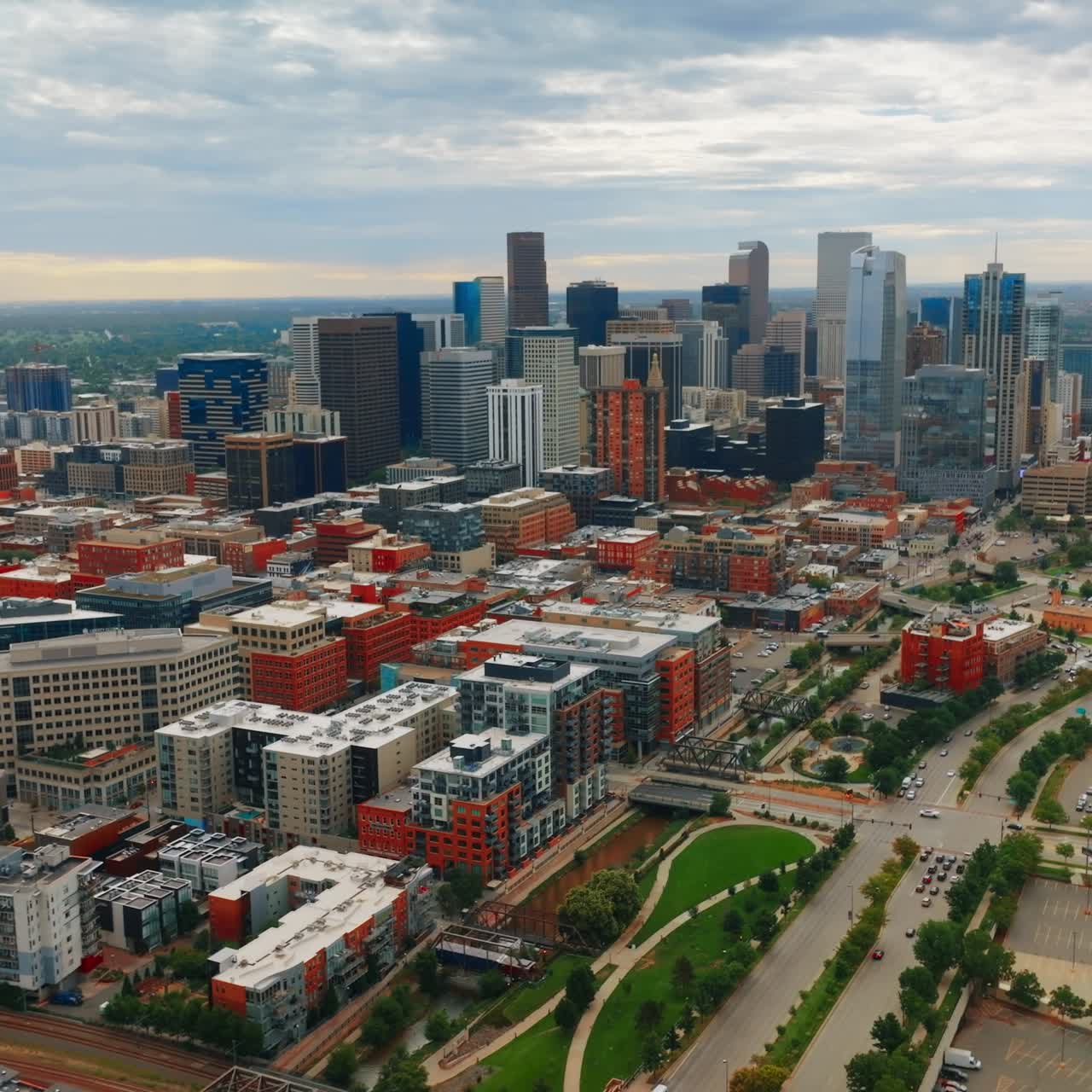 Beautiful bright Denver downtown with skyscrapers grouped together. Lovely city view on cloudy daytime from aerial perspective