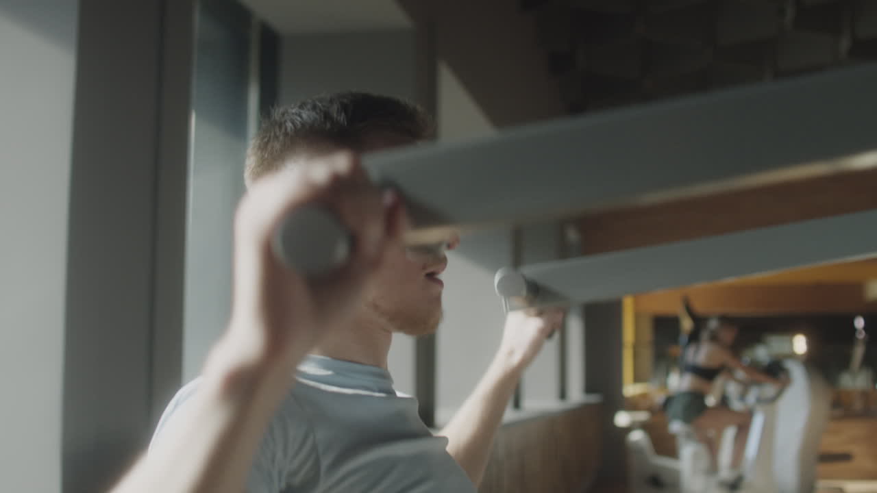 Man Exercising with Lat Pulldown Machine in Gym