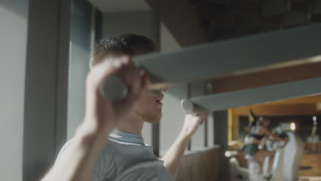 man exercising with lat pulldown machine in gym