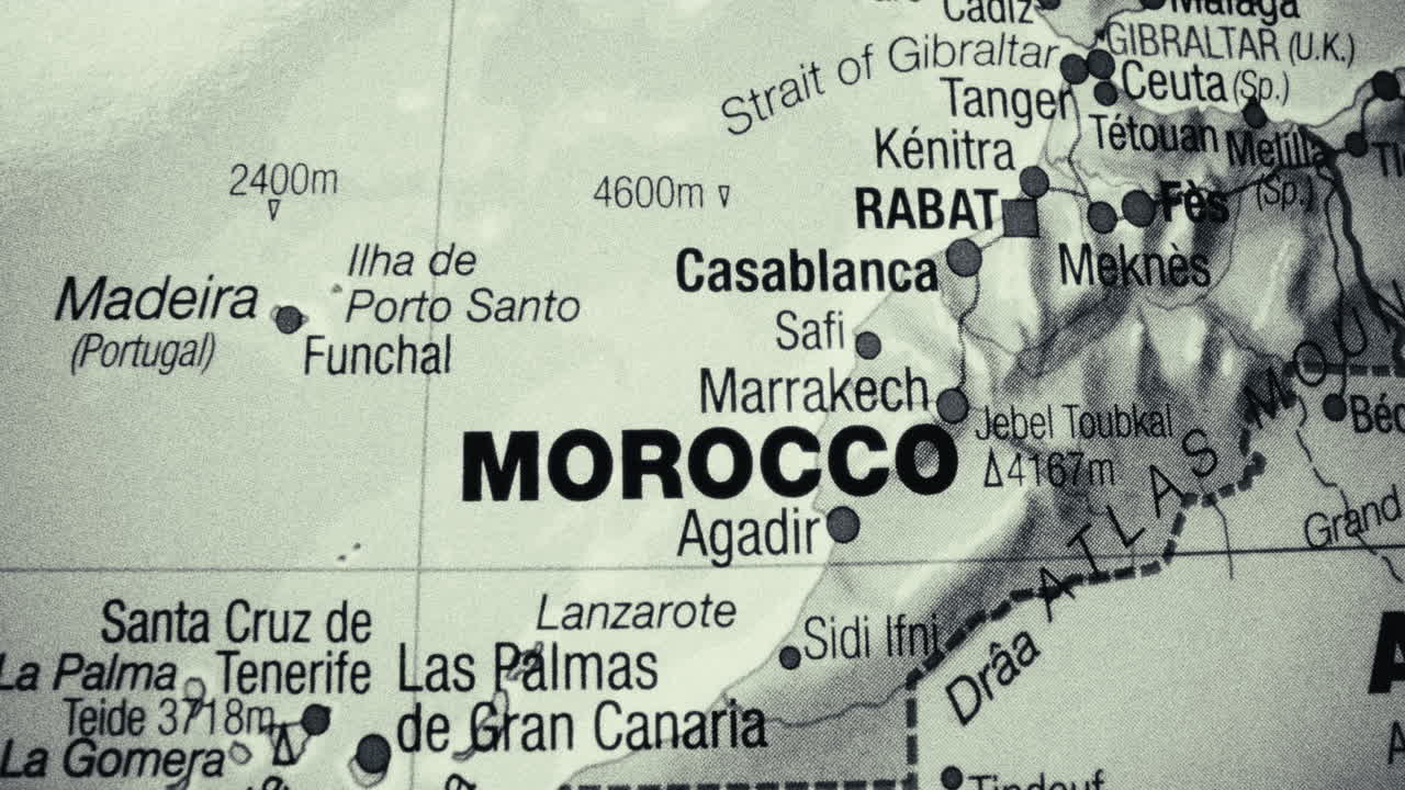 A detailed black and white map centered on Morocco, showing surrounding regions and cities