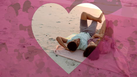 animation of hearts moving over diverse couple in love lying on beach in summer