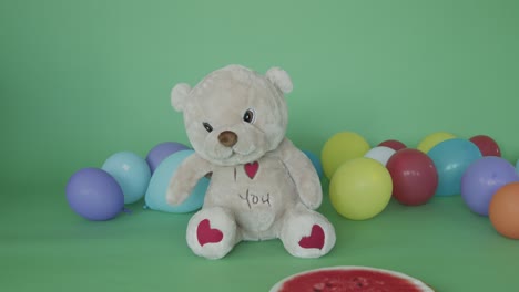 a teddy bear among balloons
