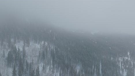 aerial shot capturing copper mountain landscape after snow storm in colorado, usa. low visibility