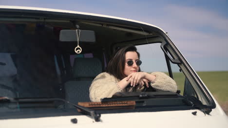 a pretty girl with sunglasses at the wheel of a caravan stopped on a lost road in the middle of the countryside 1