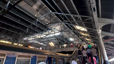 a busy scene of passengers climbing stairs at the bustling colombo train station in sri lanka, highlighting the daily commute and vibrant transportation hub.