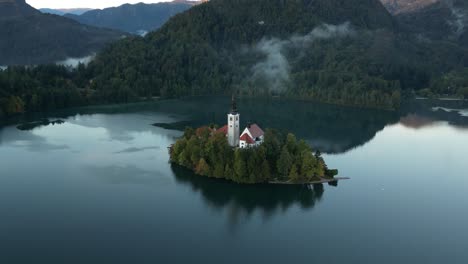 looking down at the island on lake bled during sunrise