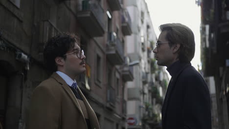 businessmen having conversation on street. colleagues standing on street