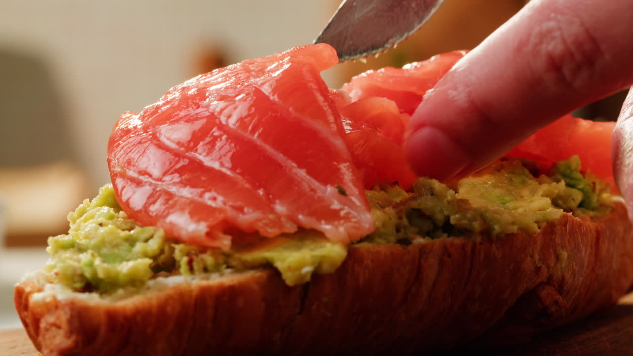 Preparing a delicious avocado toast with smoked salmon