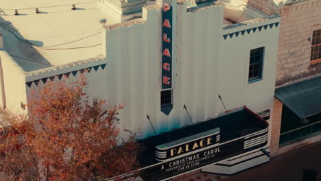 Historic-Palace-Theatre-in-downtown-Georgetown-Texas,-aerial-close-up-sweep-of-signage-4k