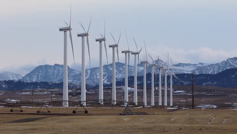 winter landscape view of wind turbines being driven by gusting chinook winds in the grassland region of south-western alberta